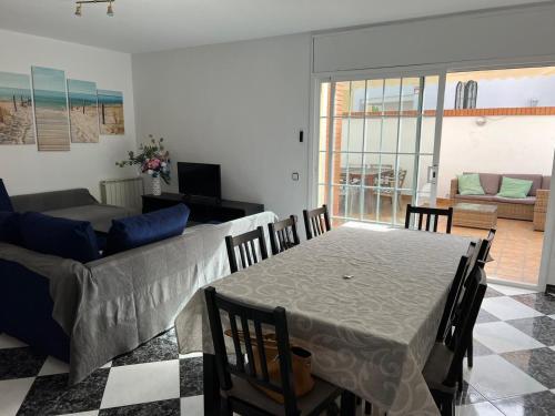 a living room with a table and a couch at Villa Arcos in Segur de Calafell