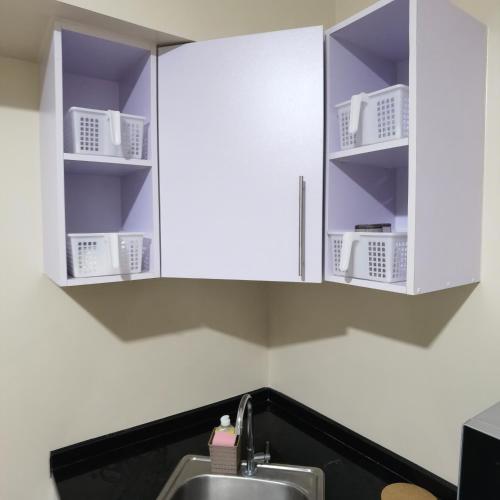 a kitchen with white cabinets and a sink at Avida Davao Condos, downtown CM Recto Avenue, Davao City in Davao City