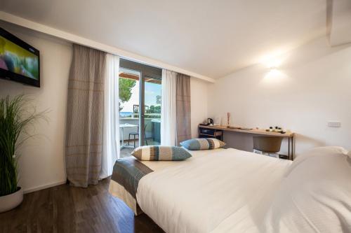 a hotel room with a bed and a window at NOHA Lifestyle Hotel - Adults Only in Pula