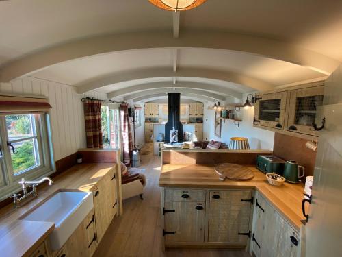 a kitchen with wooden counters and a stove top oven at Holly Lodge Boutique B&B in Thursford