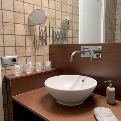 a bathroom with a white bowl sink on a counter at New Apartment La Massana - Telecabina to Bike Park in La Massana