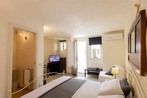 a hotel room with a bed and a television at Bella Vista b&b in Erice