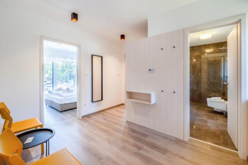 a living room with white walls and wood flooring at MyFlat Villa Nuvola in Siófok