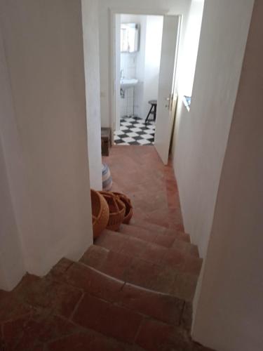 a hallway with a staircase leading to a bathroom at Casa a Serrazzano in Serrazzano