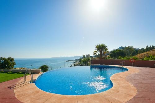 a swimming pool with a view of the ocean at SUNNY HOUSE AT THE BEACH infinity pool shared in Benalmádena