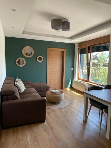 a living room with a couch and a table at Avram in Zlatibor