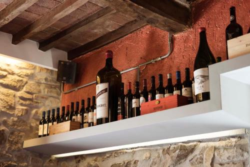 a bunch of wine bottles on a wall at Locanda La Luna in Tirli