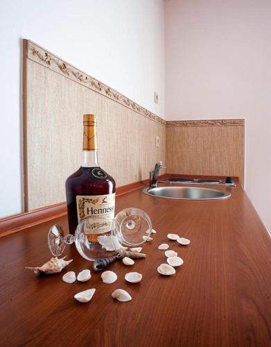 a bottle of wine and some shells on a table at Guest House Medin in Petrovac na Moru