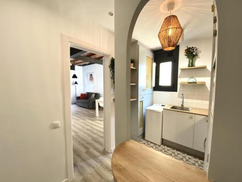 a kitchen and living room with a sink and a hallway at Sants Montjuic Olympic View in Barcelona