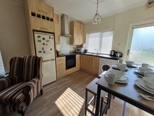 a kitchen with a table and a dining room at Farnaught Farmhouse Apartment, Lough Rynn, Mohill in Farnaght