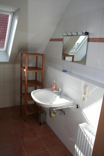 a bathroom with a sink and a mirror at Möwennest in Norddeich