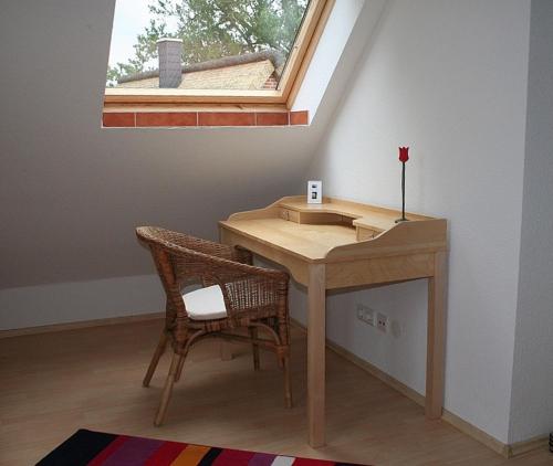 a desk in a room with a window and a chair at See in Sicht in Sternberg