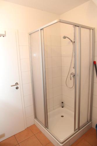 a shower with a glass enclosure in a bathroom at Ebbe in Norden