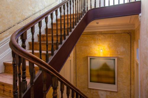 a staircase in a house with a painting on the wall at The Art Porto - Holiday Homes in Porto