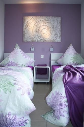 a bedroom with two beds and a tv at Kiek up de Gracht in Greetsiel