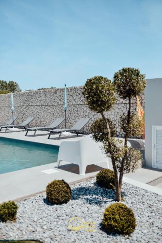a white bench sitting in front of a pool at Yellow Sweet Home - Maria e Beatriz in Nazaré