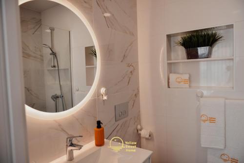 a bathroom with a sink and a mirror at Yellow Sweet Home - Maria e Beatriz in Nazaré