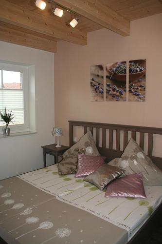 a bedroom with a bed with pillows on it at Stella Maris in Norden