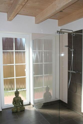a bathroom with a shower with a glass door at Stella Maris in Norden