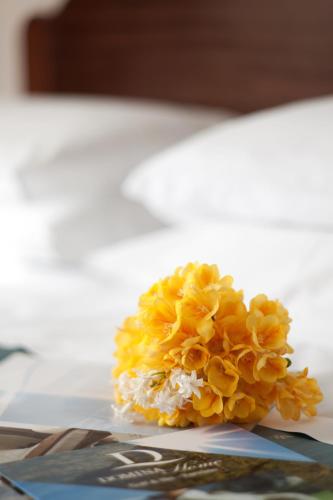 a bouquet of yellow flowers sitting on a table at Hotel Royal Positano in Positano