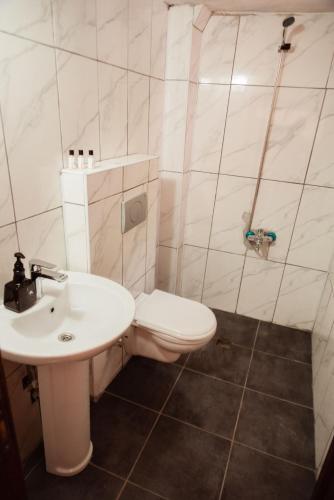 a bathroom with a toilet and a sink at Lily Town Hotel in Antalya