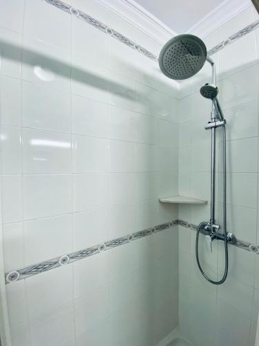 a shower with a shower head in a bathroom at Apartamentos Turísticos Santo Rostro in Chipiona