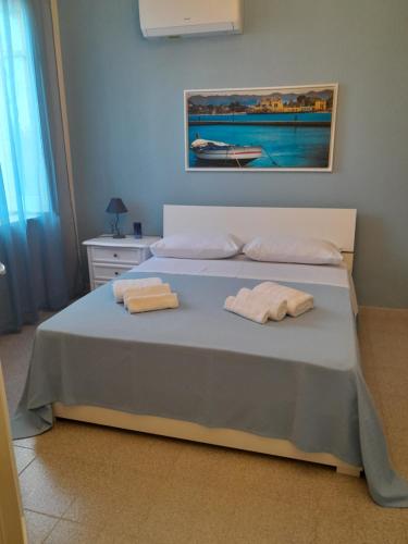 a bedroom with a bed with two towels on it at Lumera in Santa Flavia
