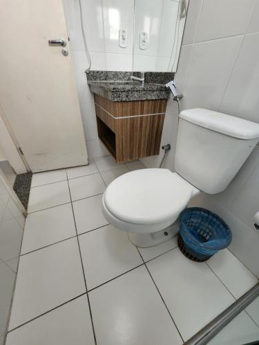 a white bathroom with a toilet and a shower at Lacqua diRoma 1 - Apartamentos JN in Caldas Novas
