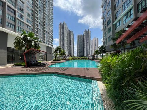 a swimming pool in a city with tall buildings at Luxurious Rustic Suite Conezion Botanical Garden IOI City Mall Putrajaya 5 plus 1 Paxs 3 Rooms 2 Baths in Putrajaya