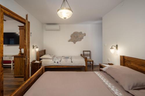 a bedroom with two beds and a light fixture at Villa Simici quiet peaceful place with pool perfect to enjoy the nature in Mošćenička Draga