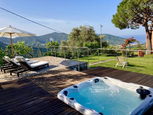 a jacuzzi tub on a deck with a table and chairs at La Vignana - 5 Terre in Levanto