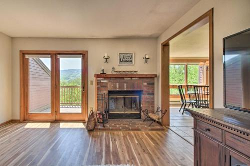 a living room with a fireplace and a tv at Timber Creek Townhome with 2 Decks and Mtn Views! in West Dover
