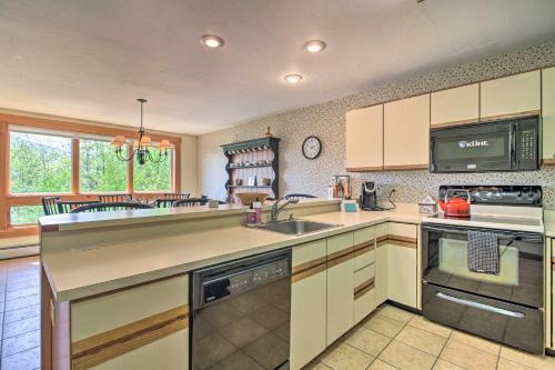 a kitchen with a sink and a stove at Timber Creek Townhome with 2 Decks and Mtn Views! in West Dover
