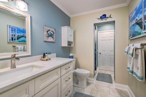 a bathroom with a sink and a toilet and a mirror at Dock and Lanai Riverview Homosassa Escape! in Homosassa