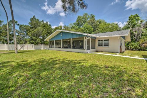 a house with a lawn in front of it at Dock and Lanai Riverview Homosassa Escape! in Homosassa