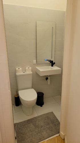 a bathroom with a white toilet and a sink at Tiny Studio Rosa - Bairro Alto in Lisbon