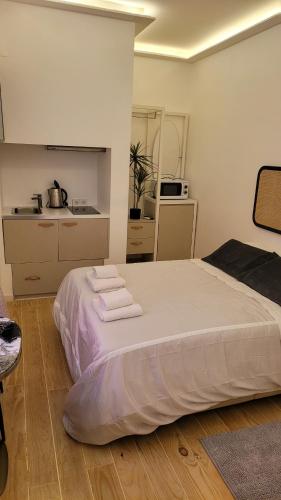 a bedroom with a bed with towels on it at Tiny Studio Rosa - Bairro Alto in Lisbon