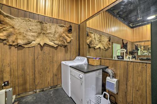a laundry room with a washer and a wooden wall at Family Leatherwood Resort Cabin with Fire Pit! in Dover