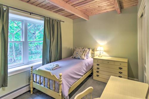 a bedroom with a bed and a dresser and a window at Spacious Bartlett Home with Fireplace and Kitchen in Bartlett
