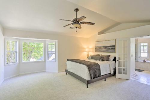 a bedroom with a bed and a ceiling fan at Redding Getaway with Hot Tub and Outdoor Kitchen! in Redding