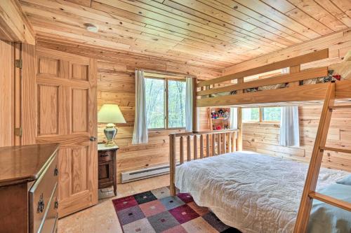 a bedroom with a bed in a wooden cabin at Waterfront Escape w/ Fire Pit in Crosslake! in Cross Lake
