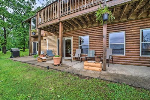 a house with a patio with a table and chairs at Boat Dock and Fire Pit Sunset Cove Lakefront Gem in Jay