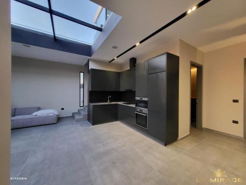 a room with a kitchen and a living room at La Mirage Villa in Rrushkull