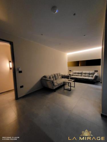 a large living room with a couch and a table at La Mirage Villa in Rrushkull