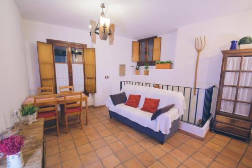 a living room with a couch and a table at Casa Rural La Buhardilla in Benaocaz