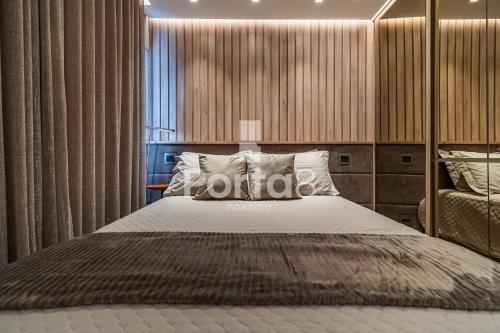 a bedroom with a large bed and a large window at Condomínio Residencial Unique Residence - São José do Rio Preto in Sao Jose do Rio Preto
