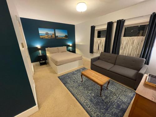 a living room with a couch and a bed at The Edenwild Boutique Inn in Lopez