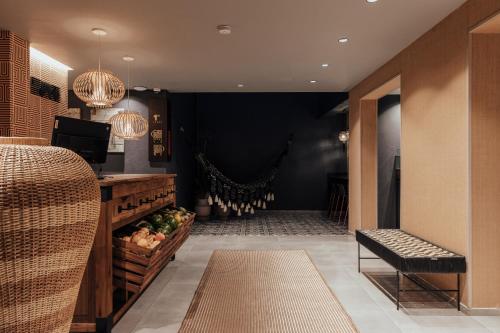 a restaurant lobby with a table and a bench at Sui Posada Boutique in Medellín