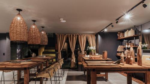 a dining room with wooden tables and chairs at Sui Boutique Hotel in Medellín