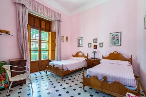 a bedroom with two beds and a window at Villa Fuente Victoria in Fuente Victoria